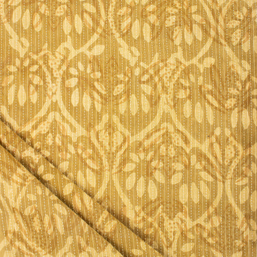 Textured fabric with a subtle pattern on a gold background